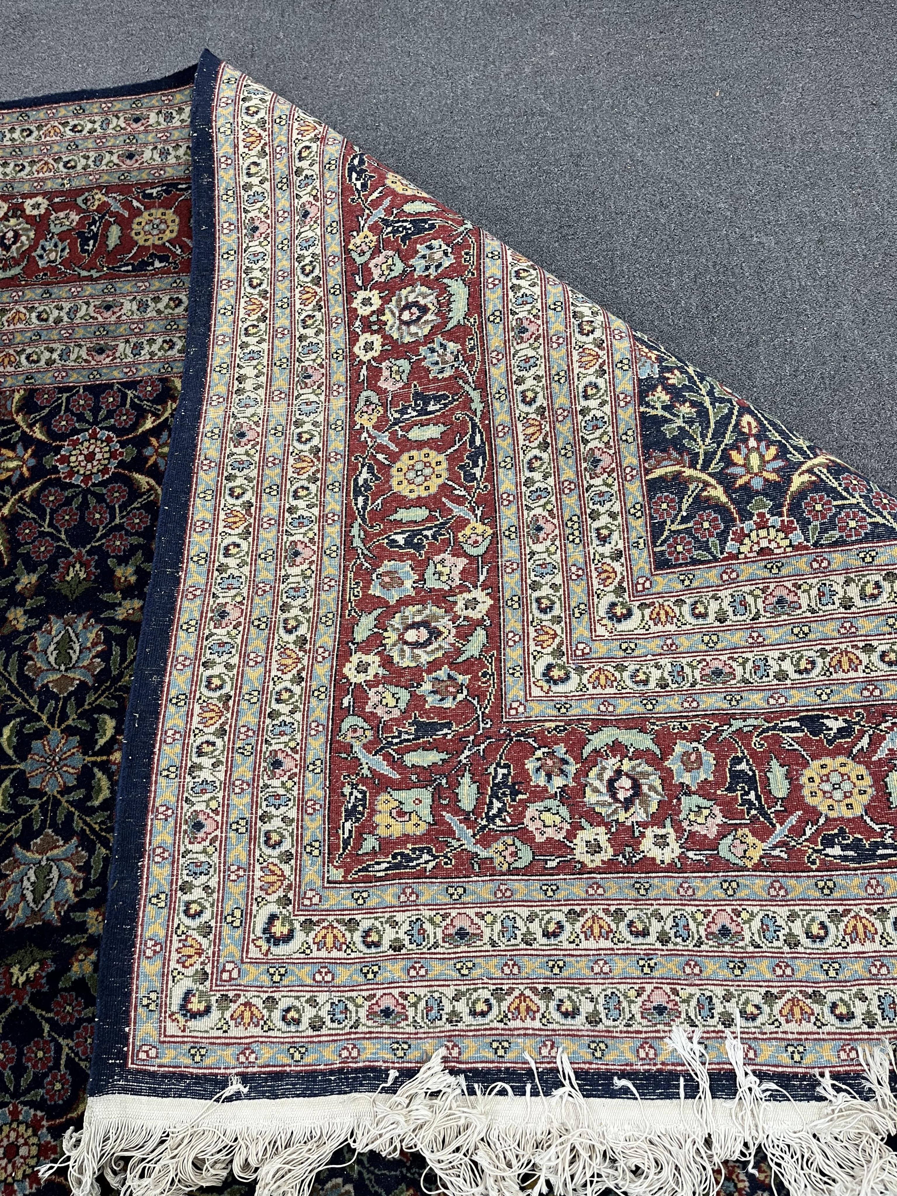 A Turkish Hereke blue ground carpet, 425 x 294cm